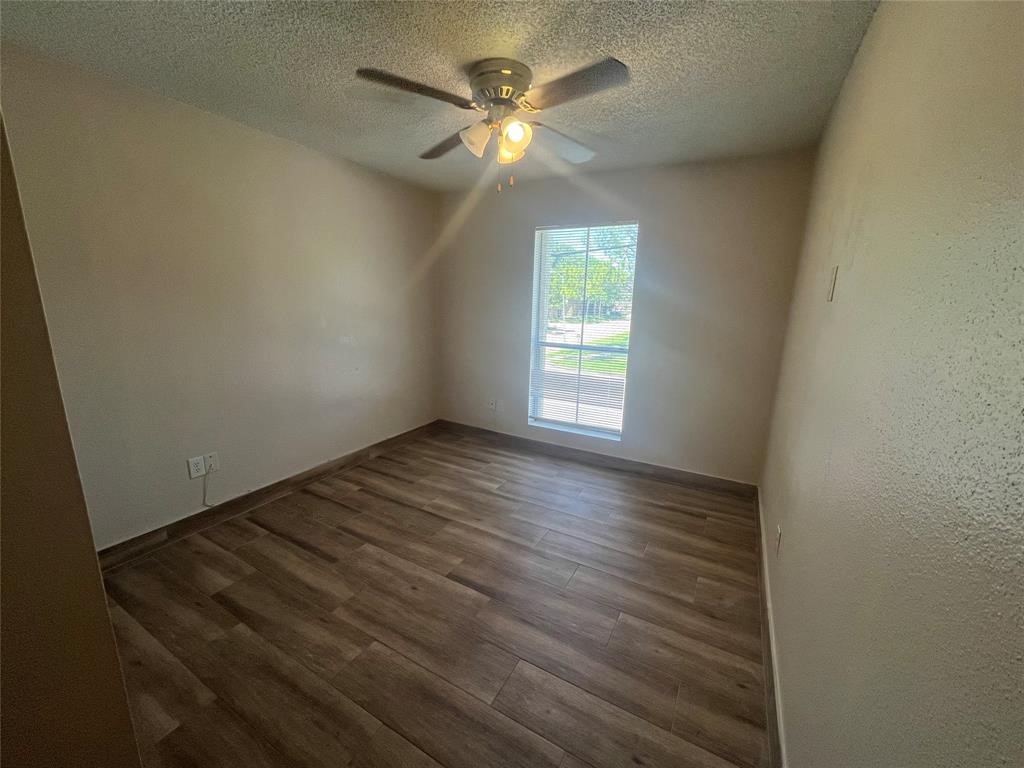 1516 Bay Area Boulevard, Unit 14 Houston, TX 77058 - Photo 12 of 19 an empty room with wooden floor and windows