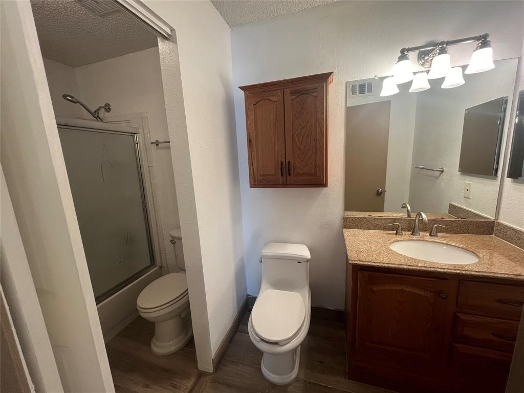 1516 Bay Area Boulevard, Unit 14 Houston, TX 77058 - Photo 19 of 19 a bathroom with a toilet sink and mirror