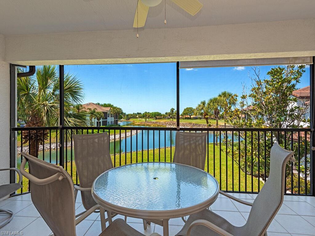 4415 Dover Court, Unit 504 Naples, FL 34105 - Photo 1 of 21 a view of a balcony with lake view and table with chairs