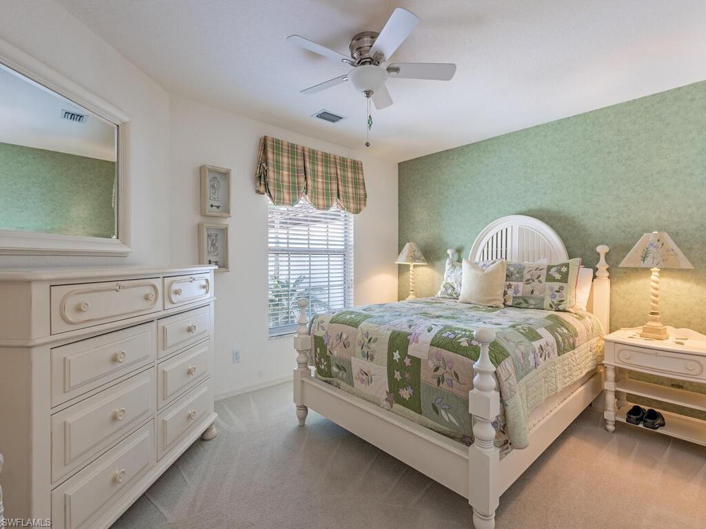4415 Dover Court, Unit 504 Naples, FL 34105 - Photo 11 of 21 a bedroom with a bed and a dresser