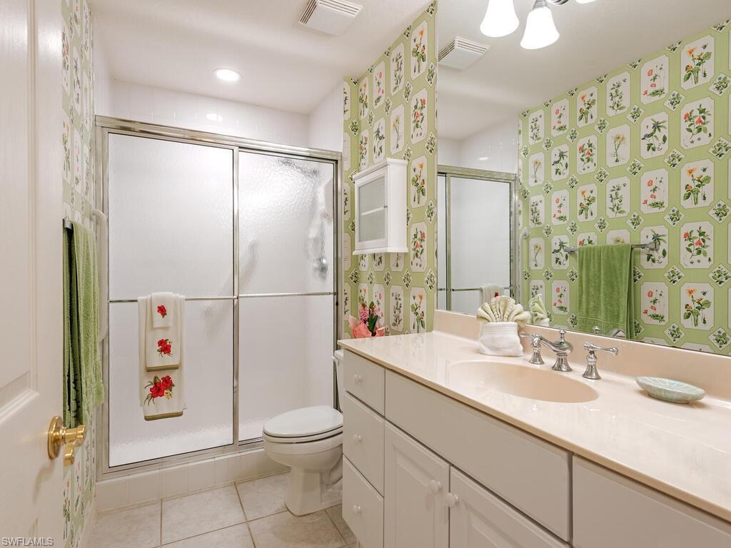 4415 Dover Court, Unit 504 Naples, FL 34105 - Photo 12 of 21 a bathroom with a sink toilet and shower