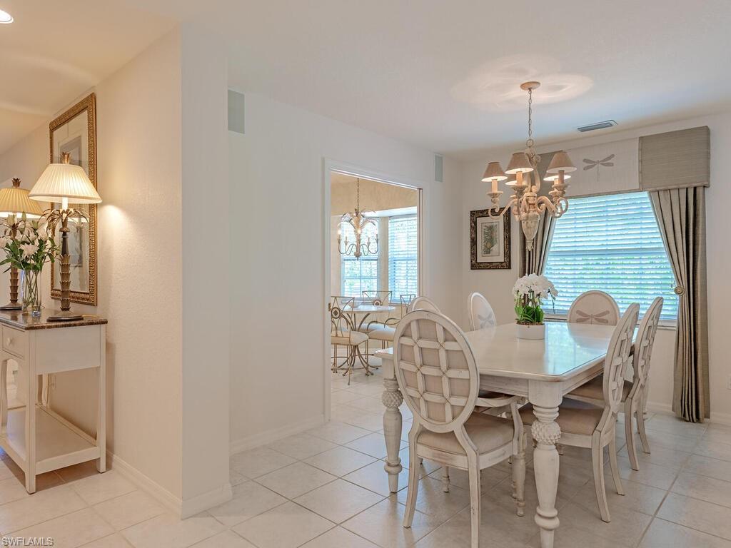 4415 Dover Court, Unit 504 Naples, FL 34105 - Photo 4 of 21 a view of a dining room with furniture and chandelier