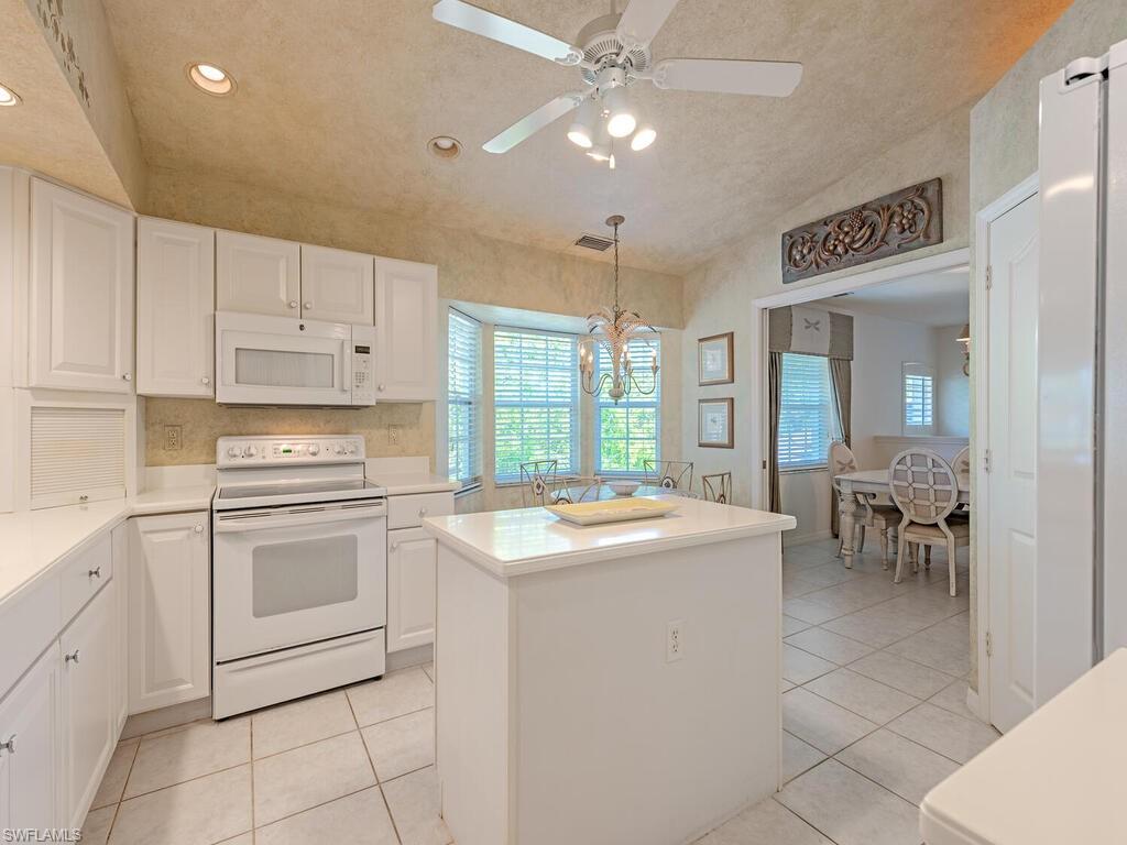 4415 Dover Court, Unit 504 Naples, FL 34105 - Photo 6 of 21 a kitchen with a stove sink and cabinets
