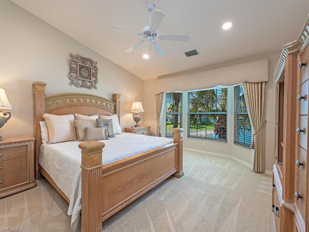 4415 Dover Court, Unit 504 Naples, FL 34105 - Photo 7 of 21 a bed sitting in a spacious bedroom next to a window
