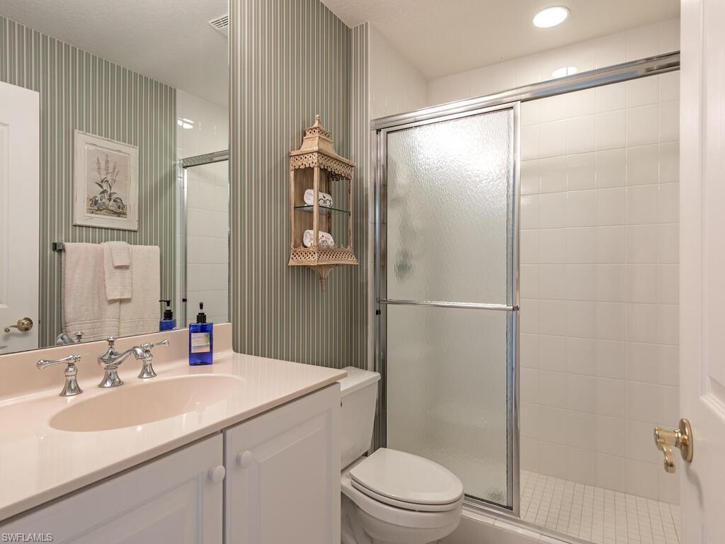 4415 Dover Court, Unit 504 Naples, FL 34105 - Photo 10 of 21 a bathroom with a sink toilet and shower