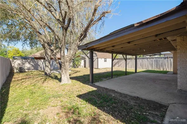 a view of backyard with large trees