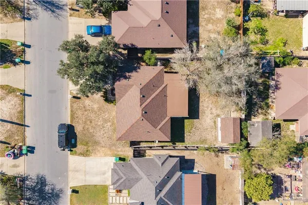 an aerial view of a house with a yard basket ball court and outdoor seating