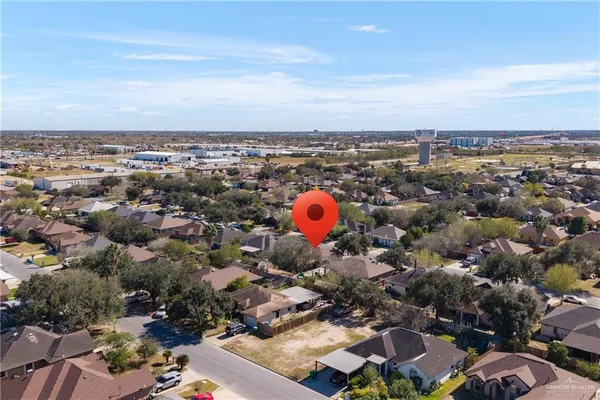 an aerial view of a building with large trees