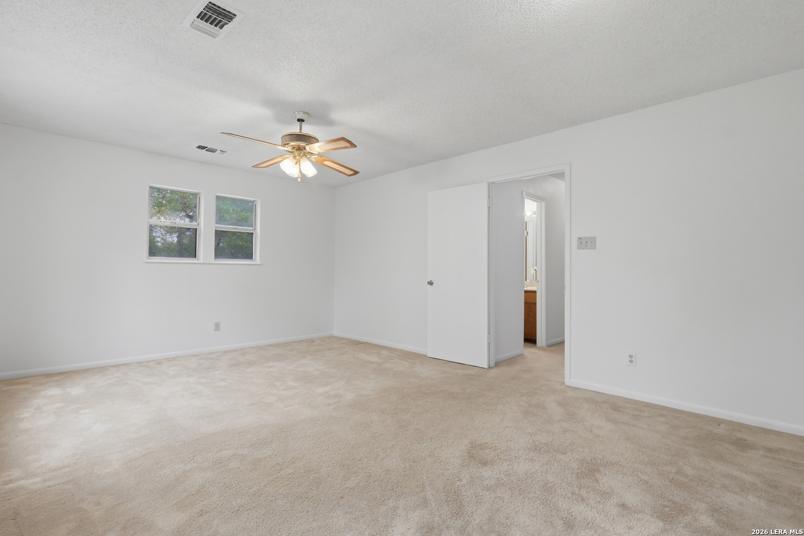 261 Fawn Lane Spring Branch, TX 78070 - Photo 21 of 44 an empty room with a ceiling fan and a window