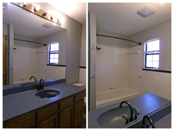 a bathroom with a sink vanity granite tub and shower