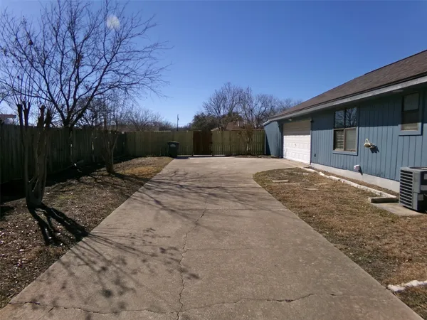 a backyard of a house with table and chairs