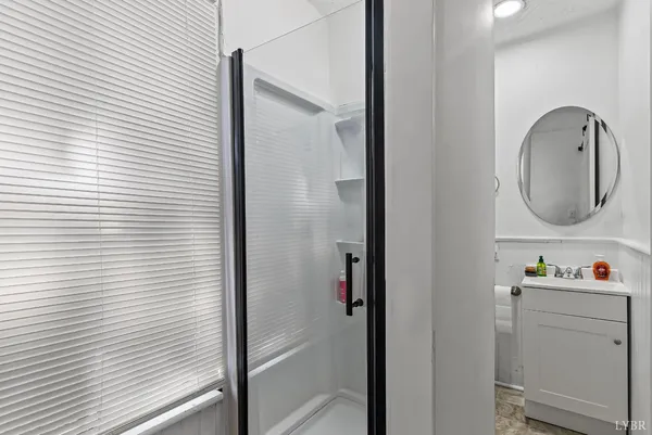 a bathroom with a sink a mirror and shower