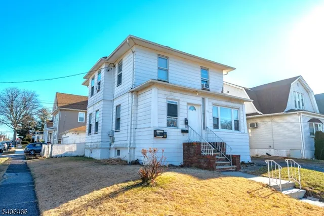 a view of a big house with a patio