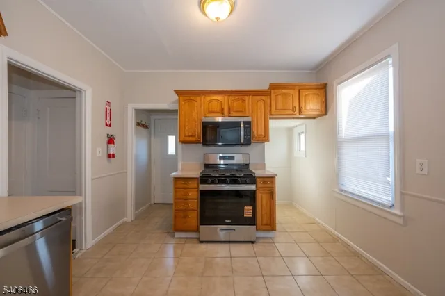 a kitchen with stainless steel appliances granite countertop a stove and a refrigerator