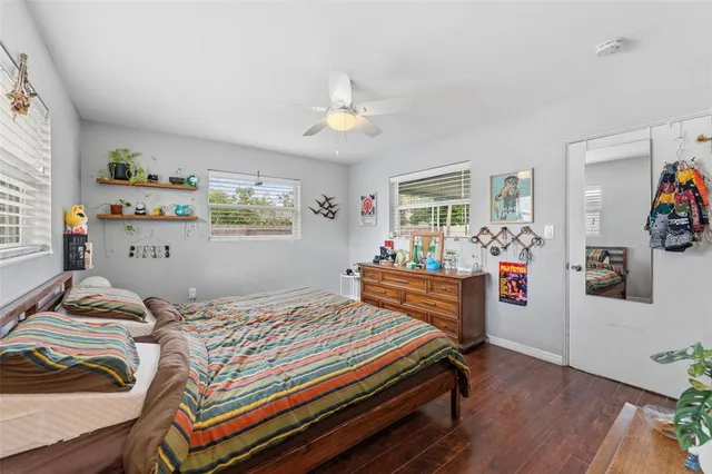 a bedroom with furniture and a wooden floor