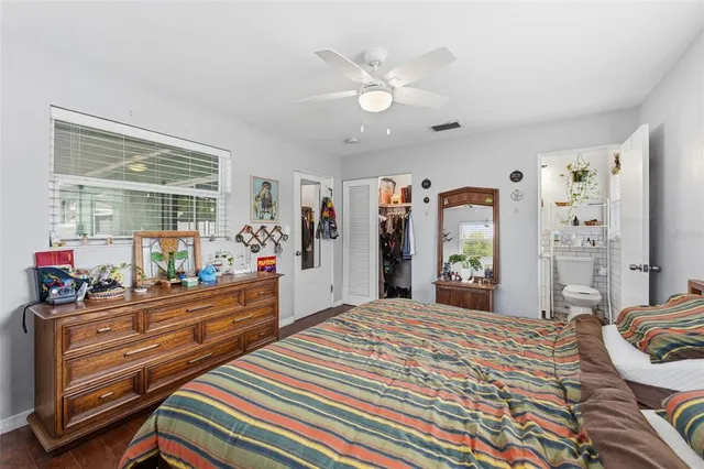a bedroom with a bed and a large window with the outer view