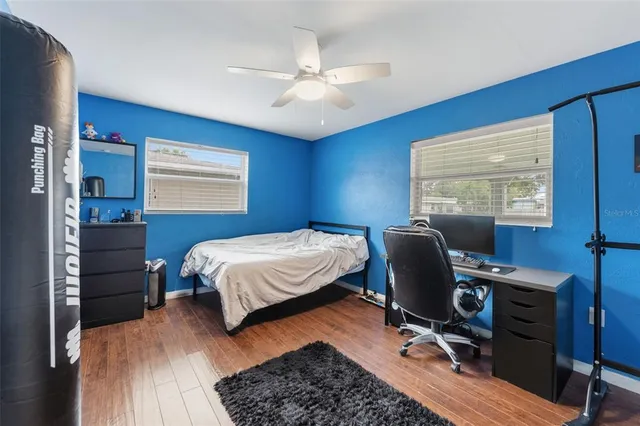 a bedroom with a large bed and a chandelier