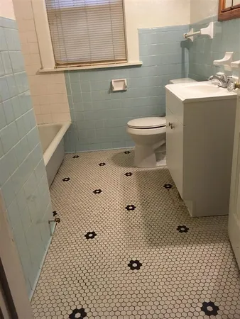a kitchen with a refrigerator sink and cabinets