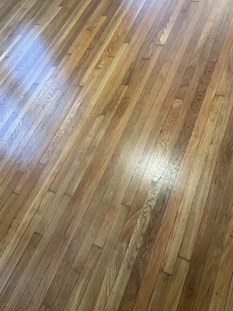 a view of an empty room and wooden floor
