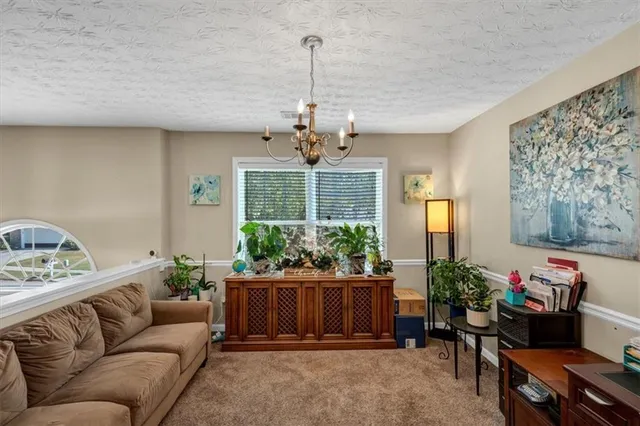 a living room with furniture and a chandelier