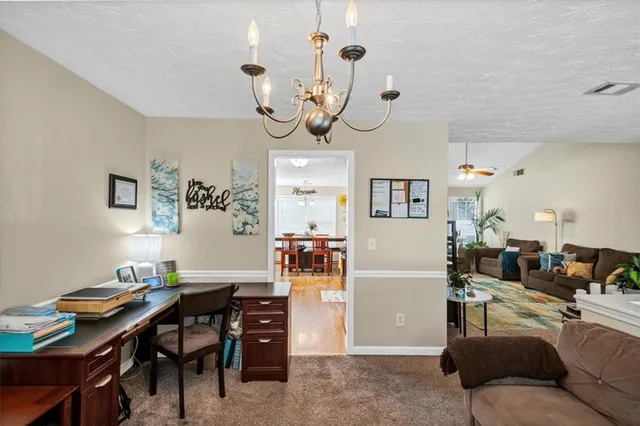 a living room with furniture kitchen view and a dining table