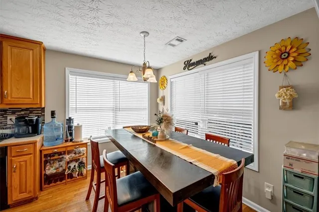 a view of a dining room with furniture and window