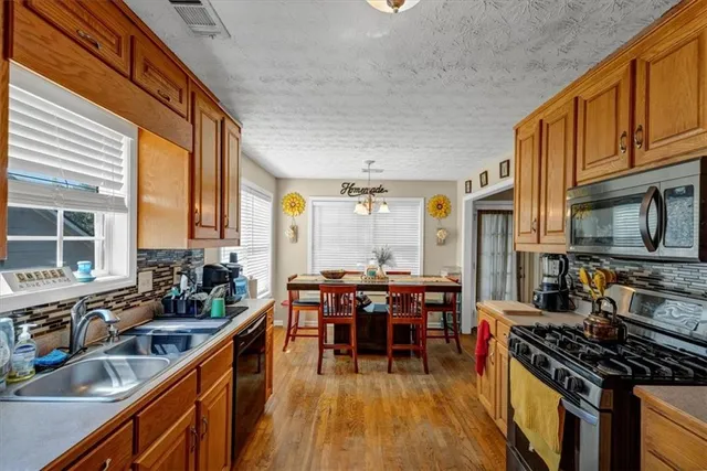a kitchen with lots of counter top space and wooden floor