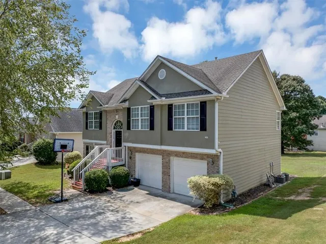 a house that has a small yard and a large tree