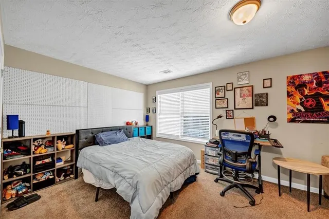 a bedroom with a bed and a book shelf