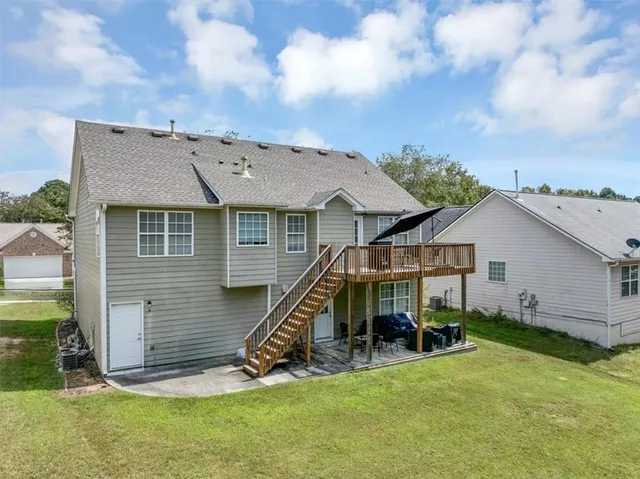 a view of a house with a yard and sitting area