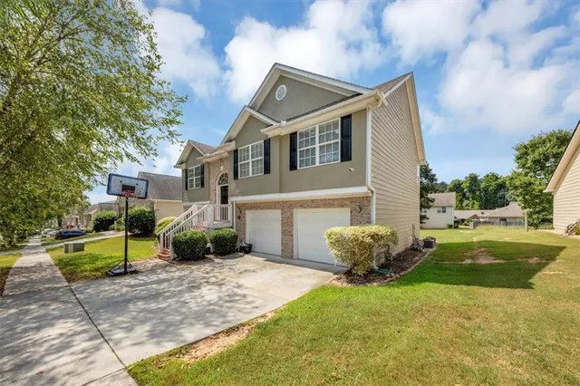 a view of a house with a yard and a garden