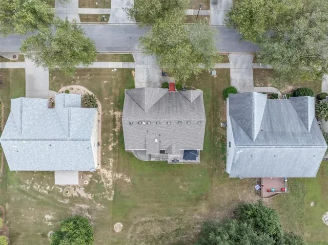 a view of a house with a yard and a fountain
