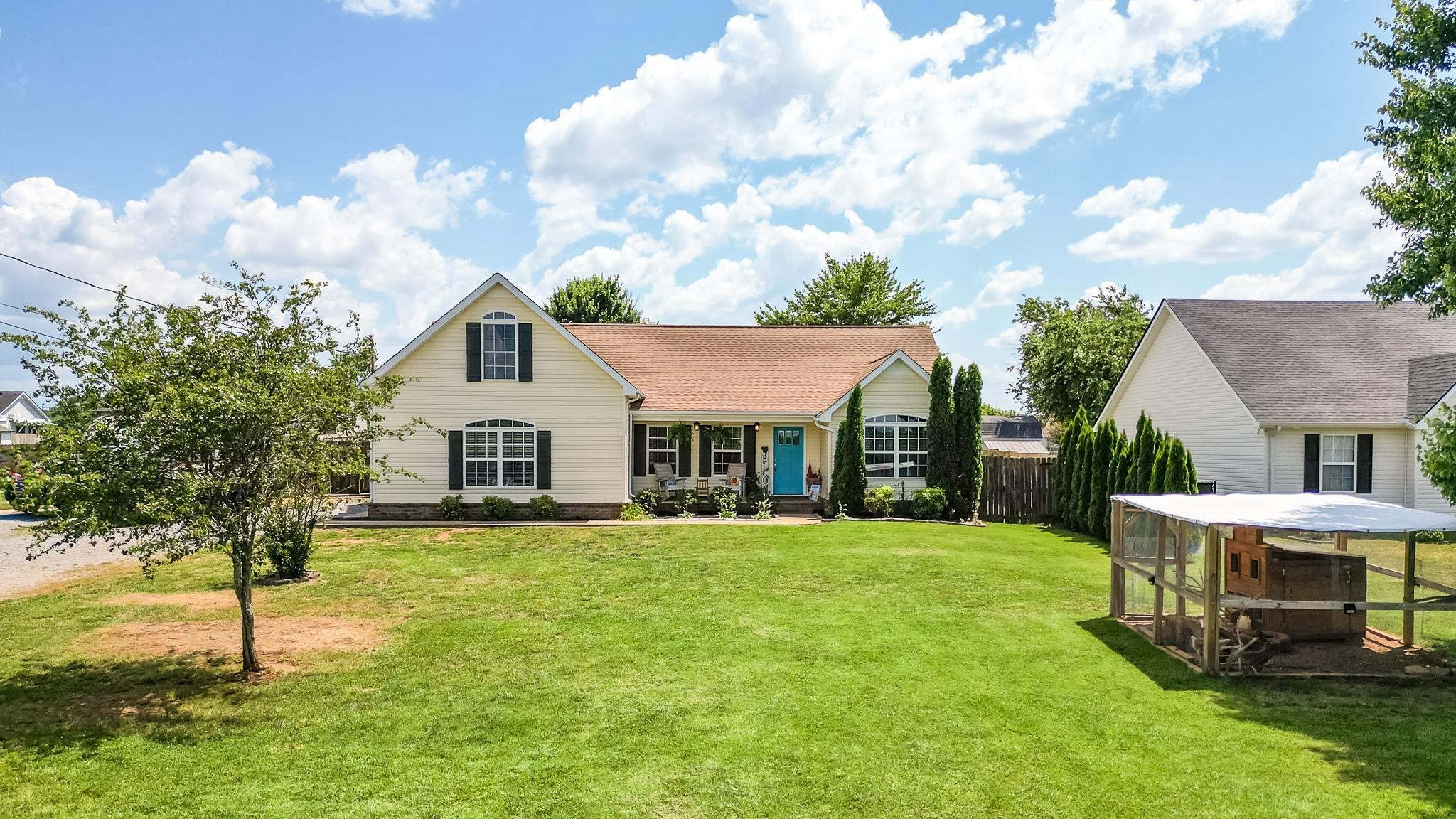 5039 Midland Fosterville Road Bell Buckle, TN 37020 - Photo 1 of 32 a front view of a house with garden