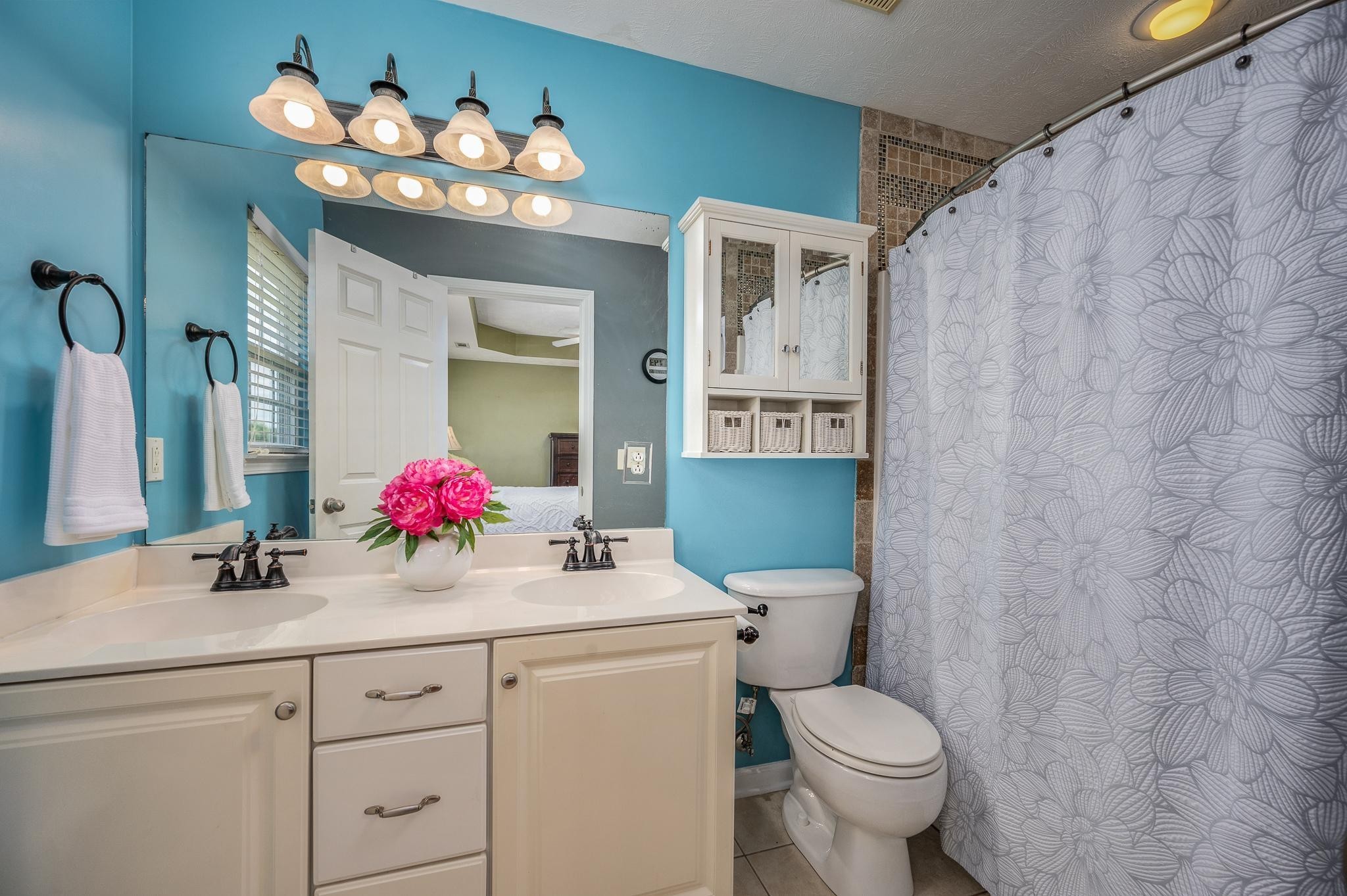 5039 Midland Fosterville Road Bell Buckle, TN 37020 - Photo 16 of 32 a bathroom with a sink vanity mirror and toilet
