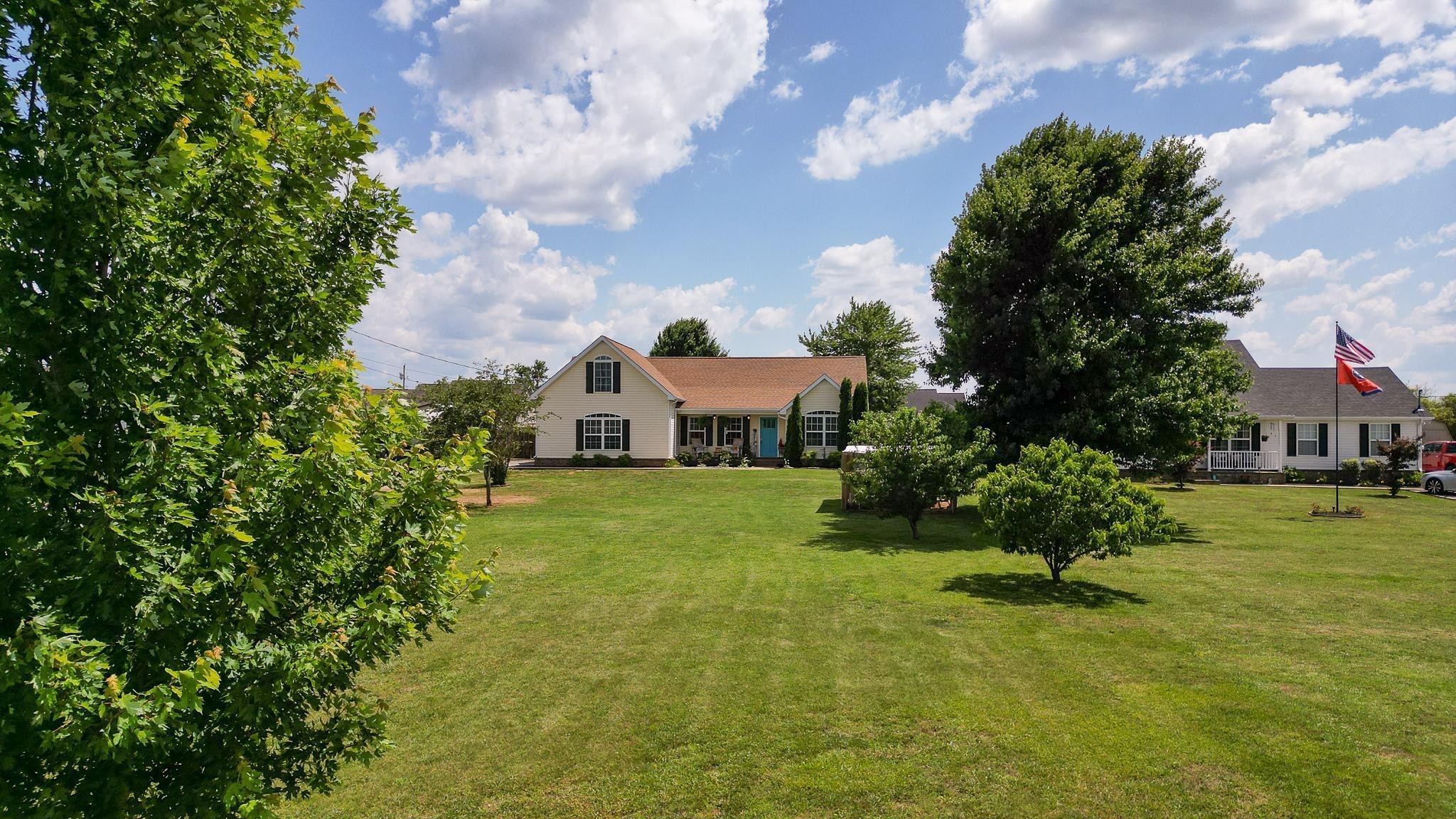 5039 Midland Fosterville Road Bell Buckle, TN 37020 - Photo 2 of 32 a front view of a house with a garden