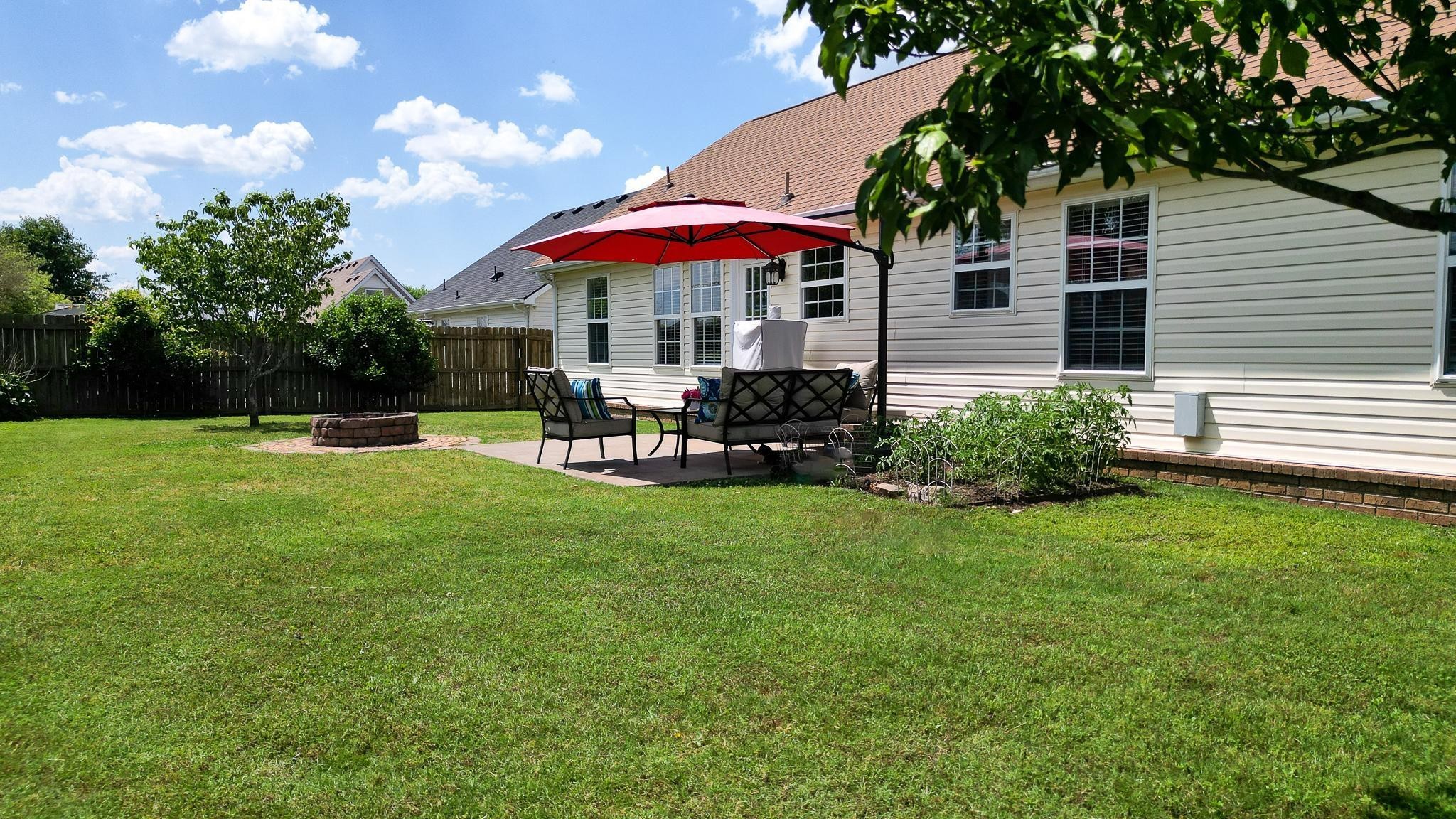 5039 Midland Fosterville Road Bell Buckle, TN 37020 - Photo 21 of 32 a view of a house with a yard and sitting area