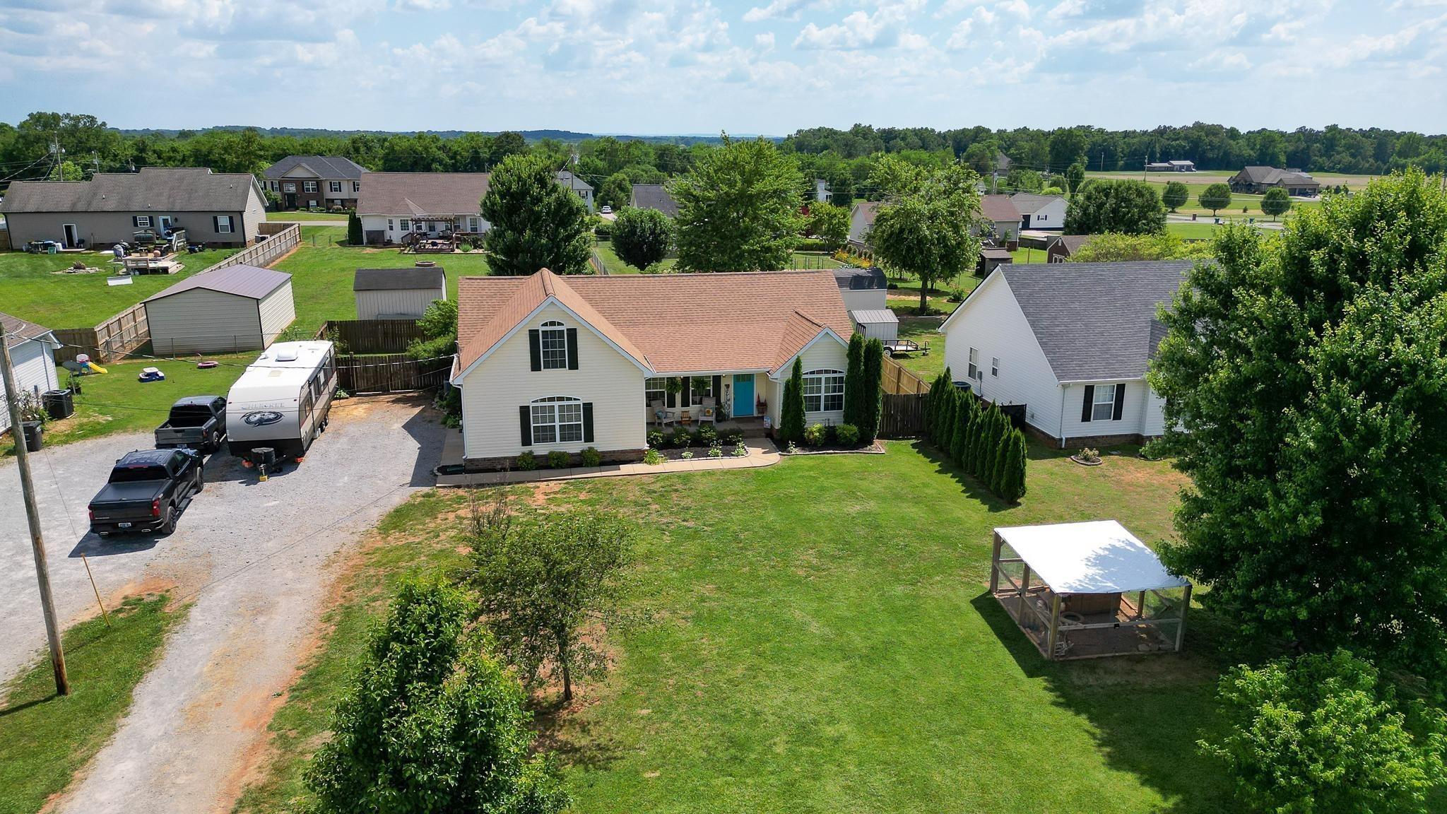 5039 Midland Fosterville Road Bell Buckle, TN 37020 - Photo 25 of 32 an aerial view of a house with a garden and lake view