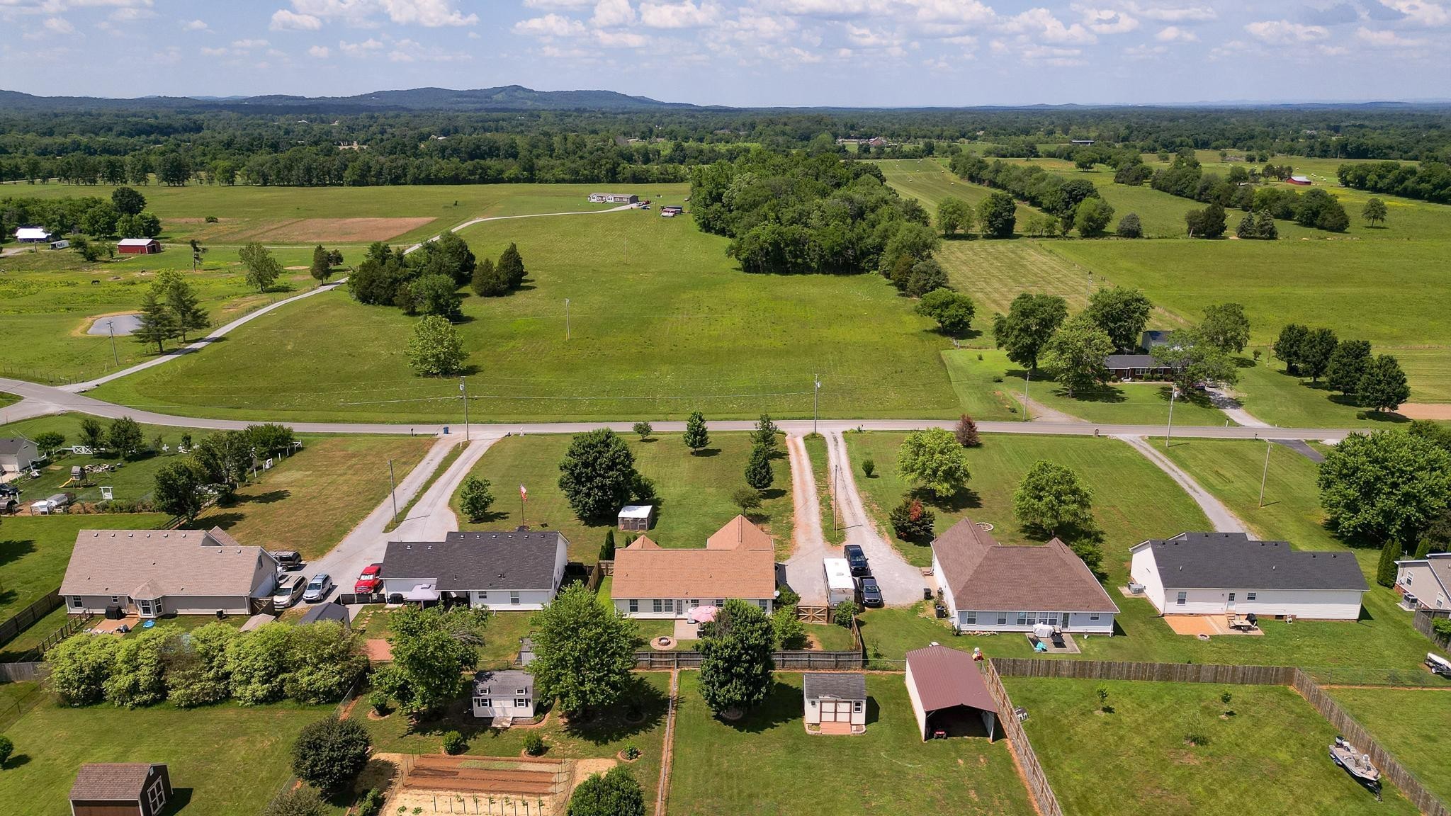 5039 Midland Fosterville Road Bell Buckle, TN 37020 - Photo 27 of 32 an aerial view of a house with a lake view