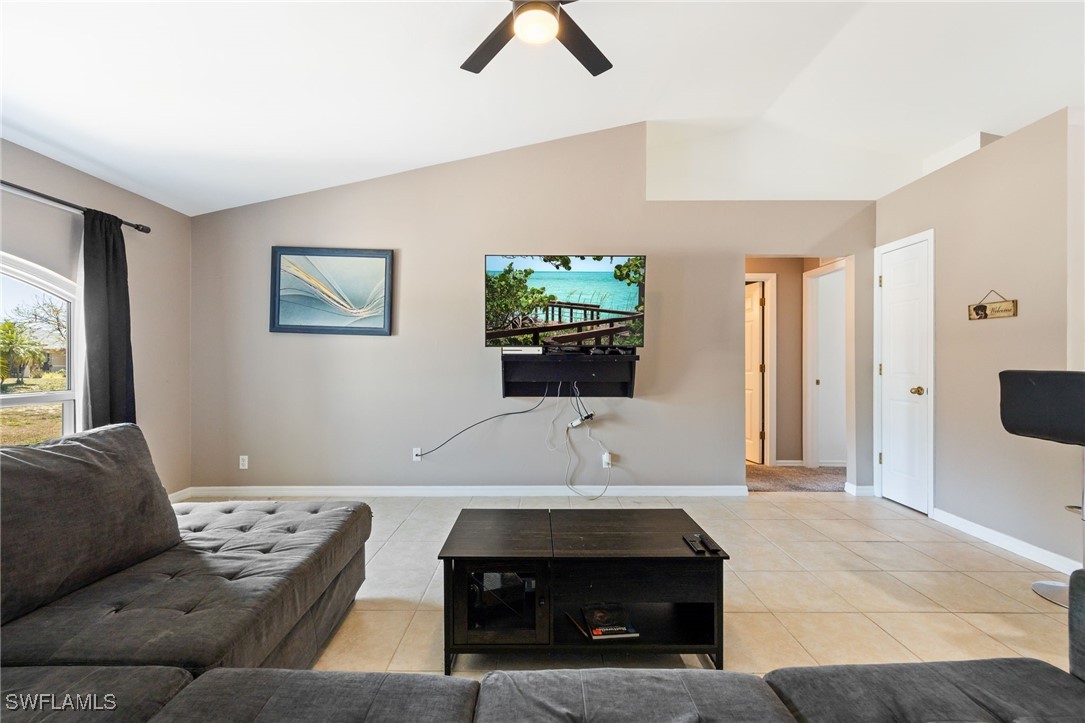 217 Manatee Street Fort Myers, FL 33913 - Photo 11 of 39 a living room with furniture and a flat screen tv