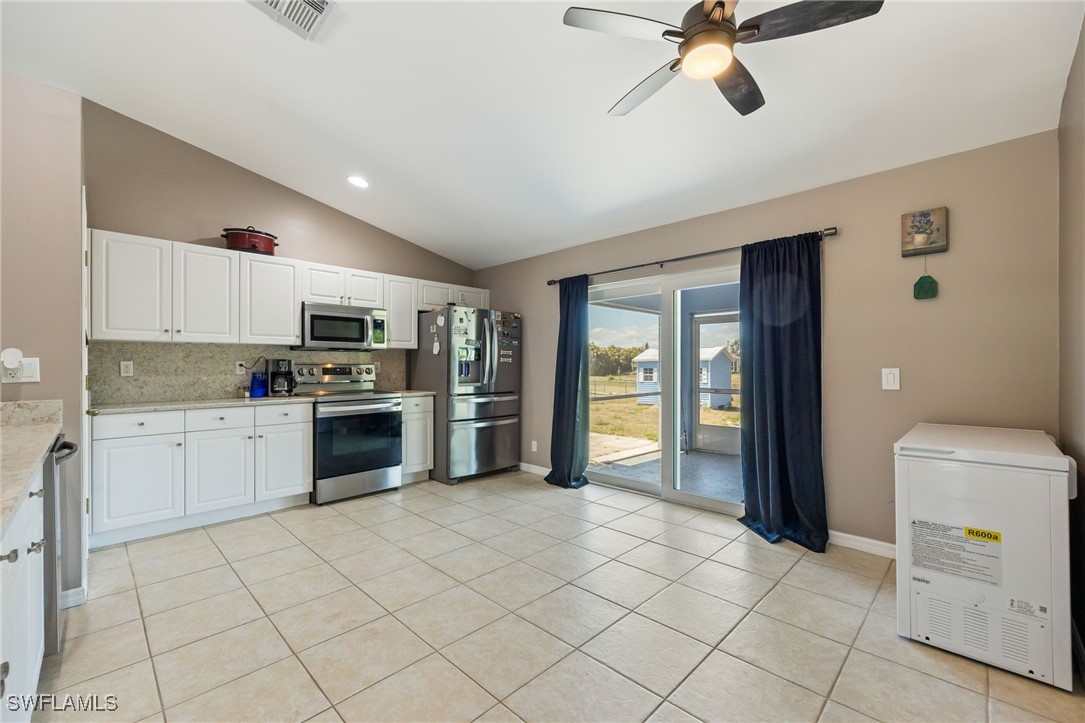 217 Manatee Street Fort Myers, FL 33913 - Photo 16 of 39 a kitchen with granite countertop cabinets and stainless steel appliances