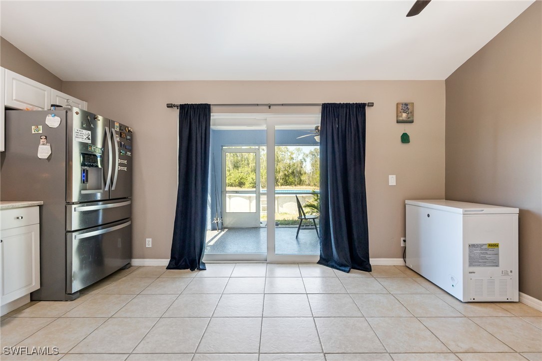 217 Manatee Street Fort Myers, FL 33913 - Photo 18 of 39 a view of a kitchen with refrigerator and more cabinets