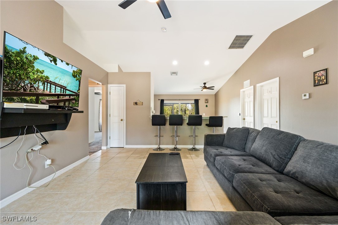 217 Manatee Street Fort Myers, FL 33913 - Photo 4 of 39 a living room with furniture and a flat screen tv