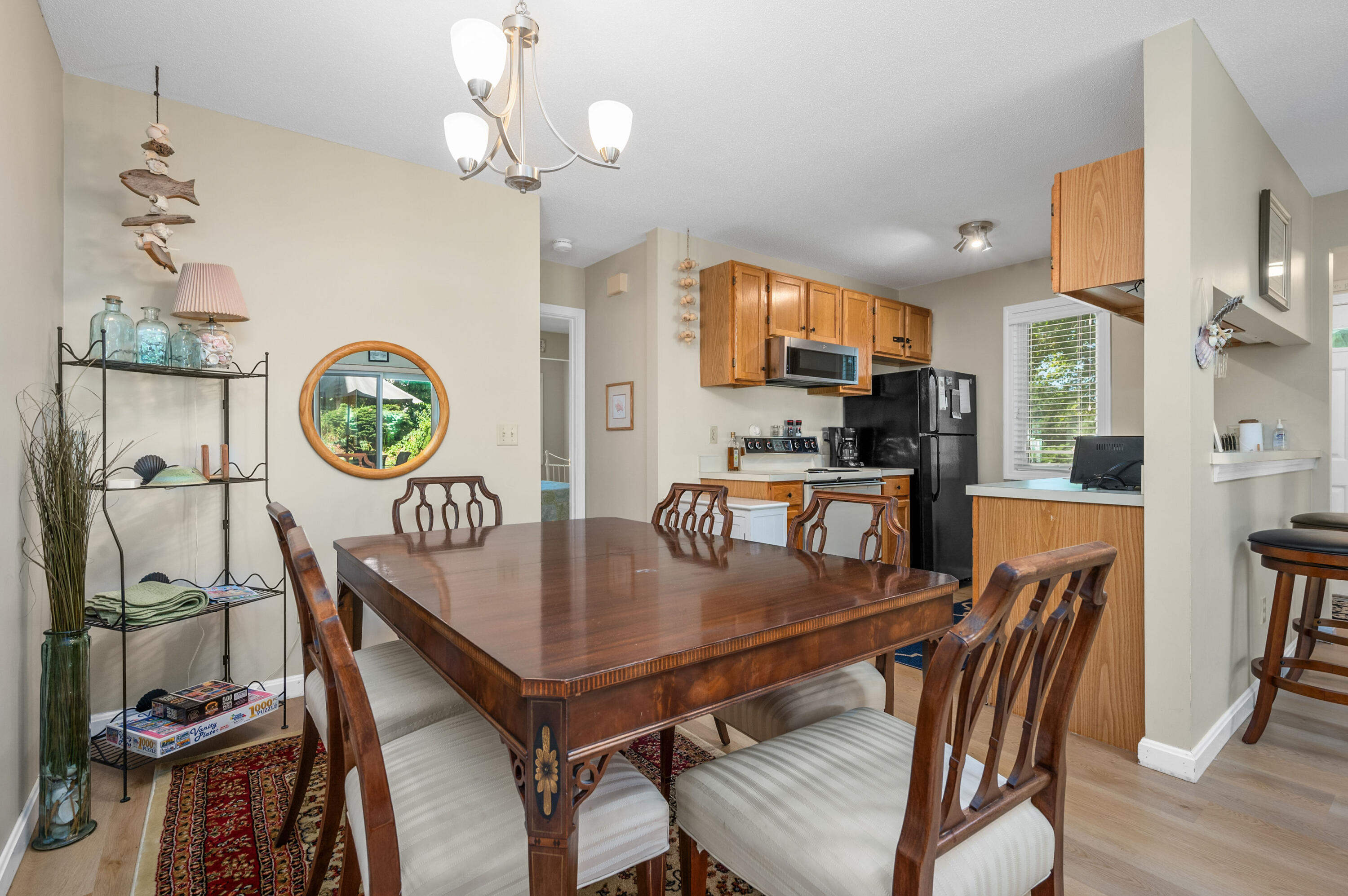 1 Howland Circle Brewster, MA 02631 - Photo 15 of 29 a dining room with a wooden table a table and chairs