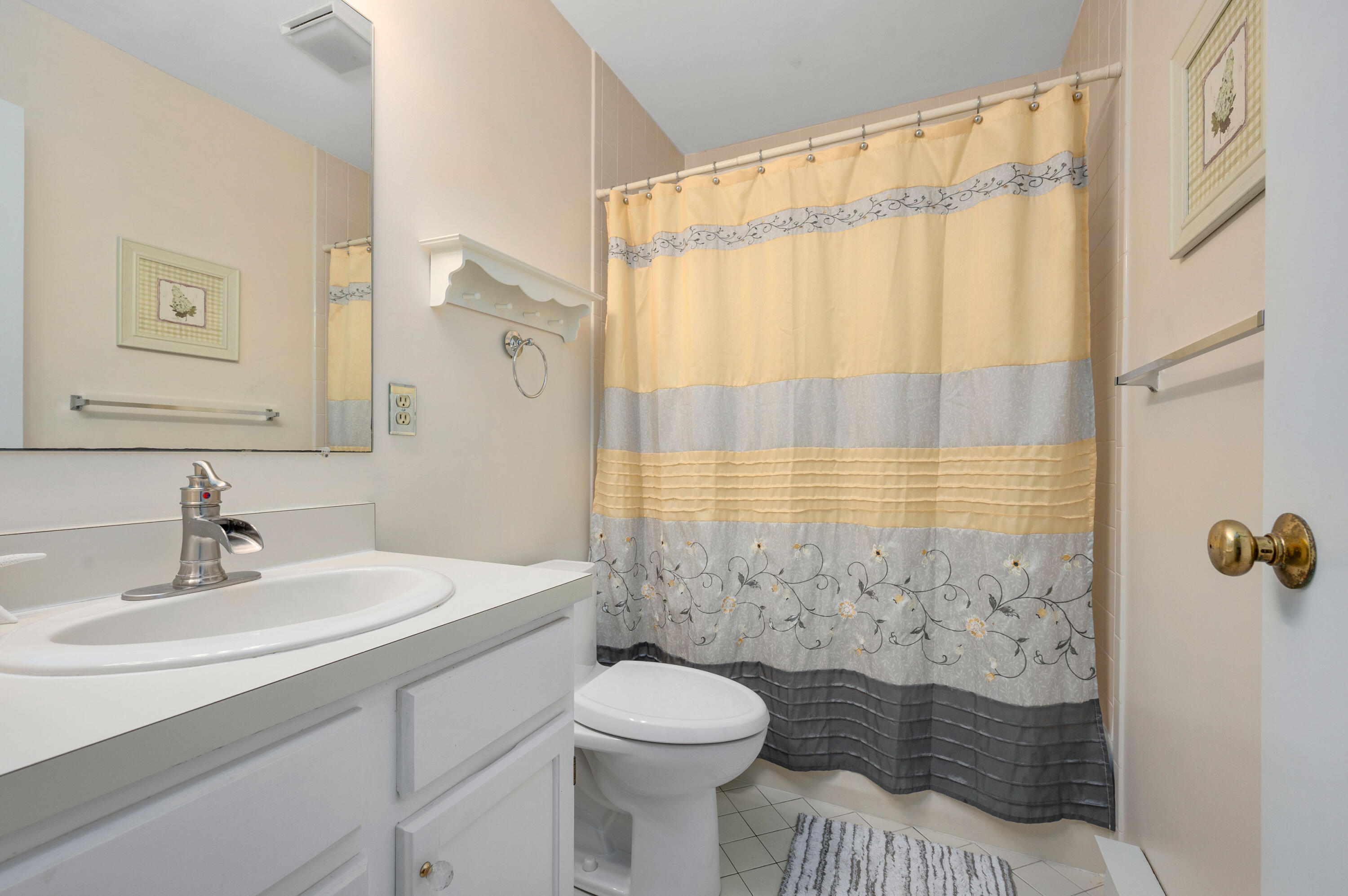 1 Howland Circle Brewster, MA 02631 - Photo 18 of 29 a bathroom with a sink a toilet and shower curtain