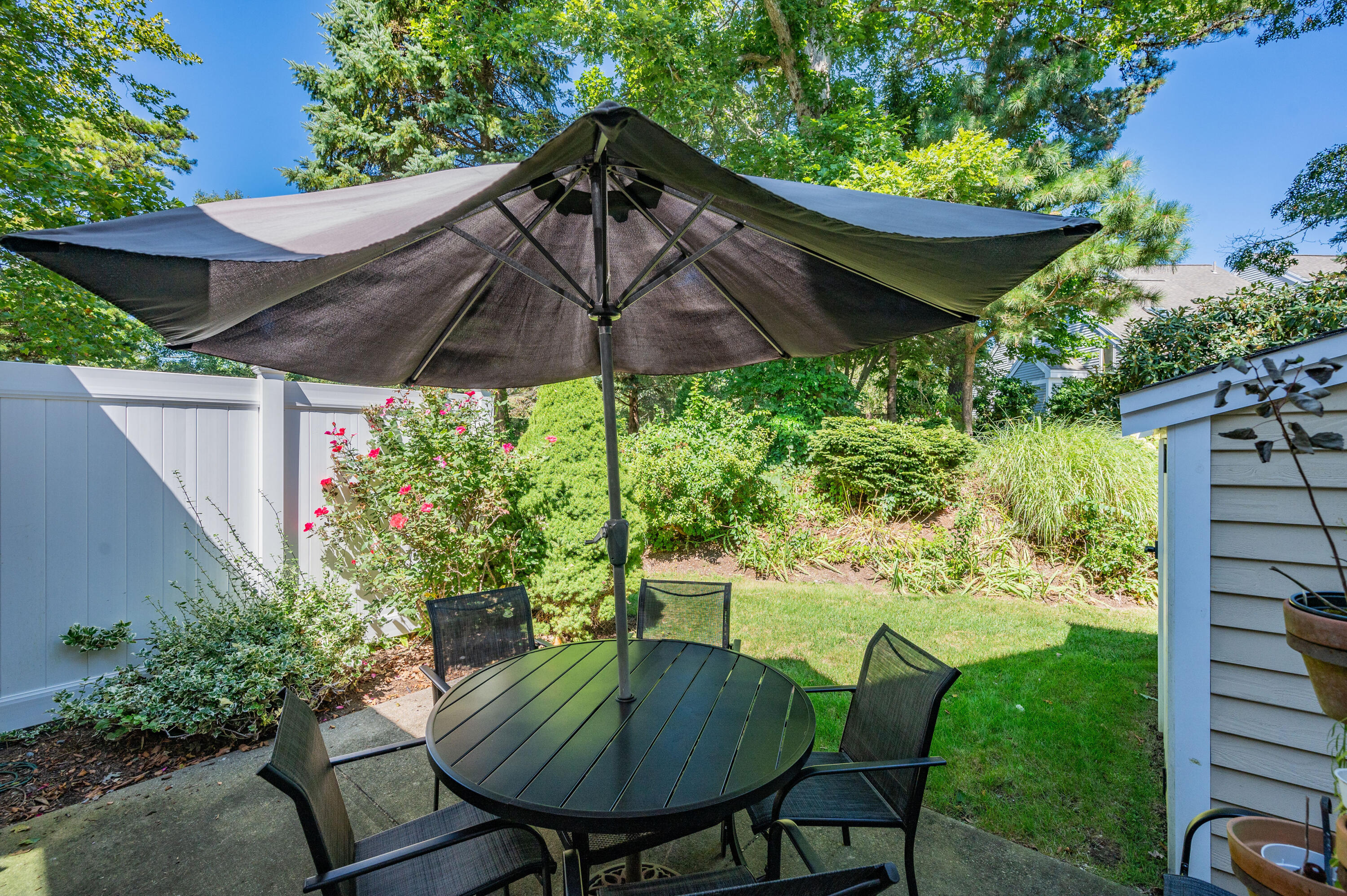 1 Howland Circle Brewster, MA 02631 - Photo 28 of 29 a view of a backyard with furniture and a garden