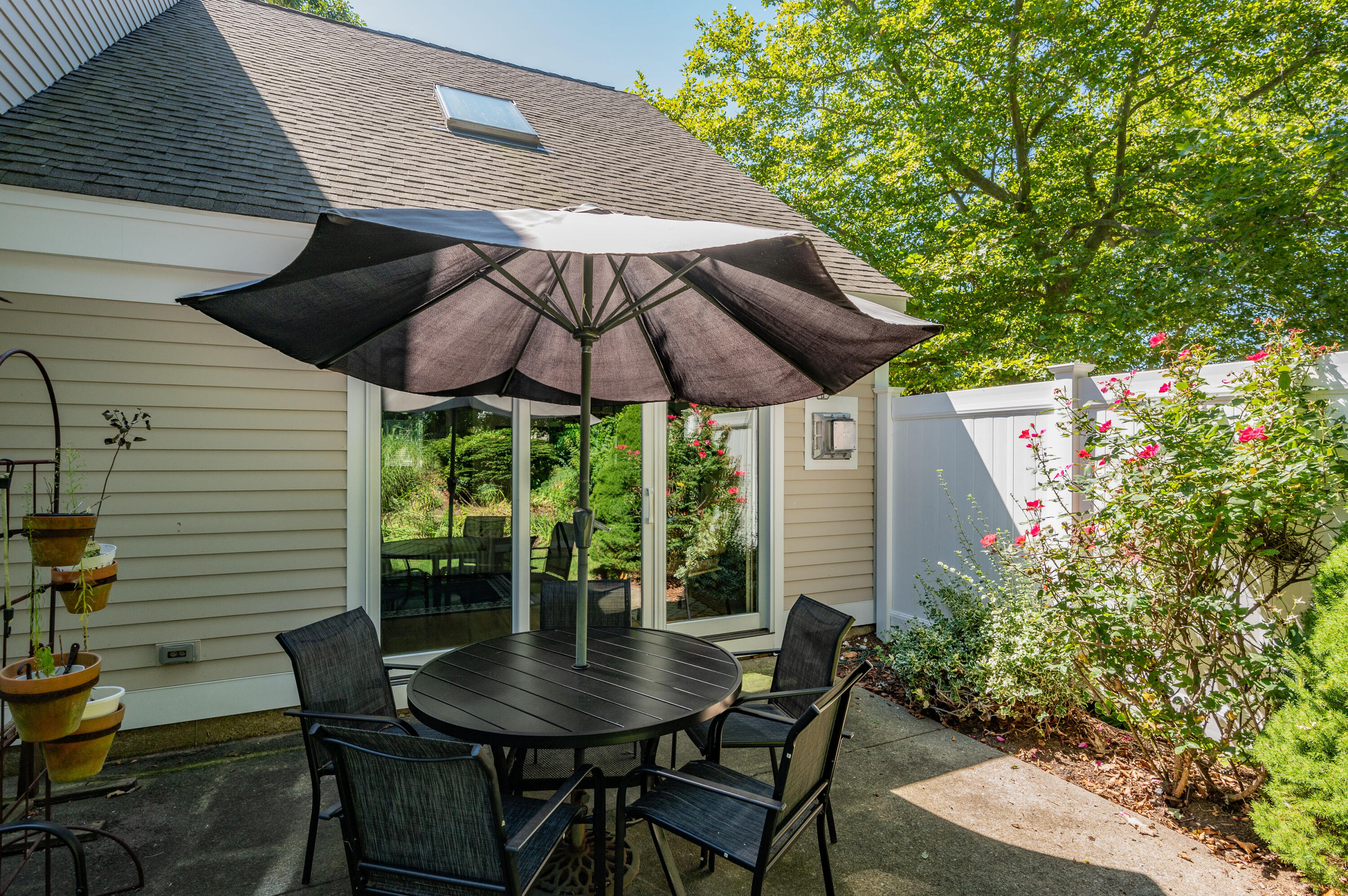 1 Howland Circle Brewster, MA 02631 - Photo 29 of 29 a patio with a patio table and chairs