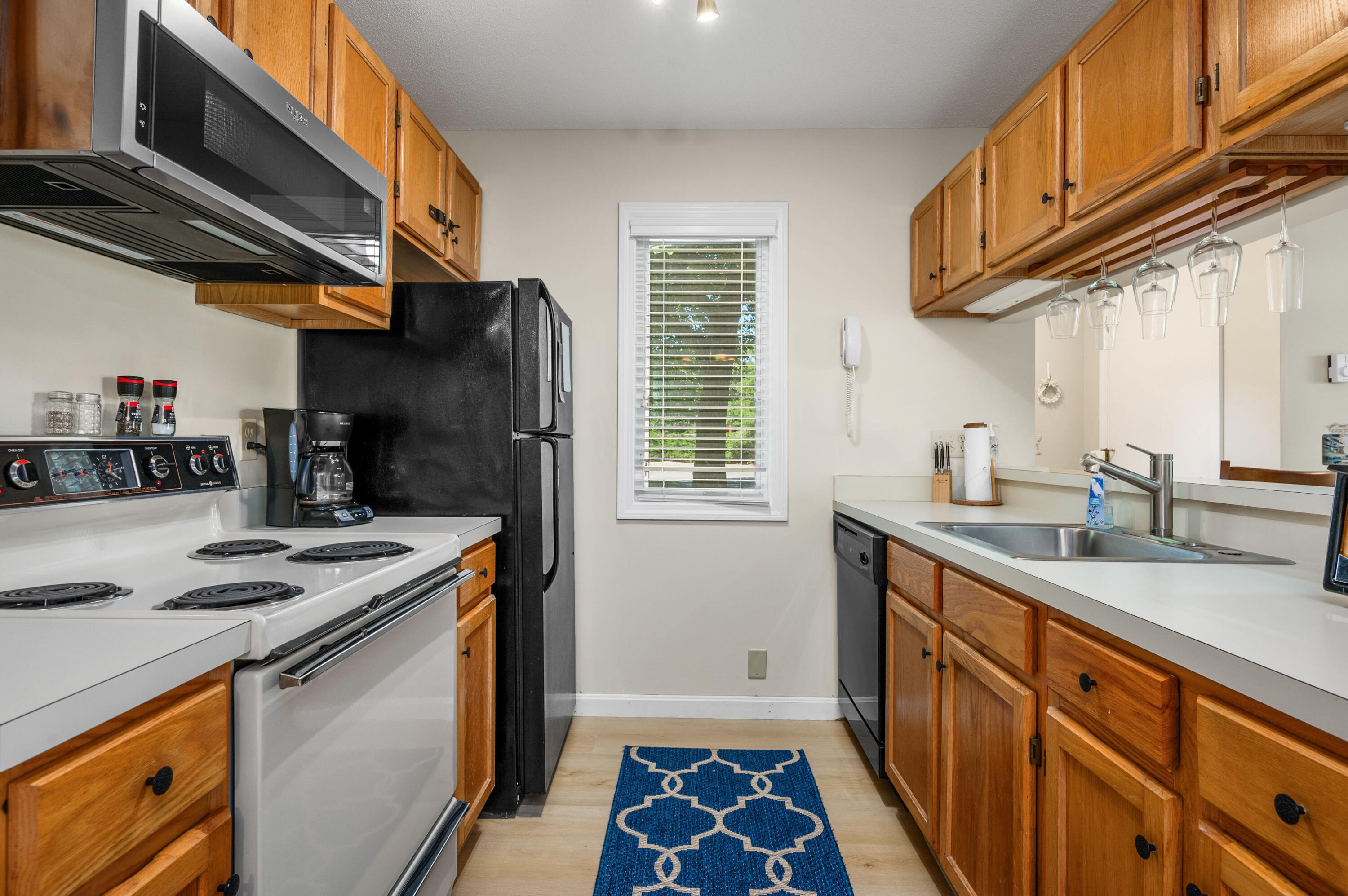 1 Howland Circle Brewster, MA 02631 - Photo 6 of 29 a kitchen with stainless steel appliances granite countertop a sink a stove and a refrigerator