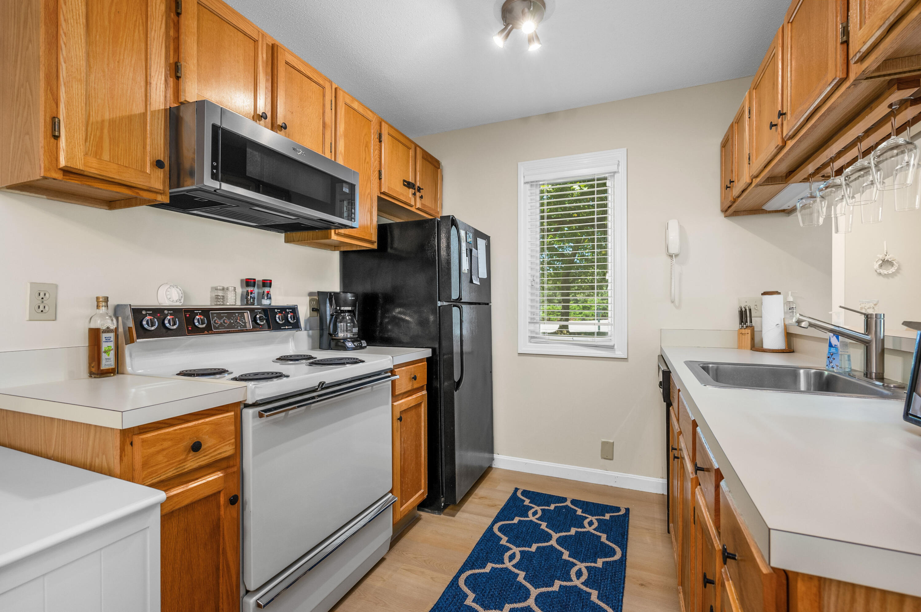 1 Howland Circle Brewster, MA 02631 - Photo 7 of 29 a kitchen with stainless steel appliances granite countertop a sink a stove a microwave cabinets and a refrigerator