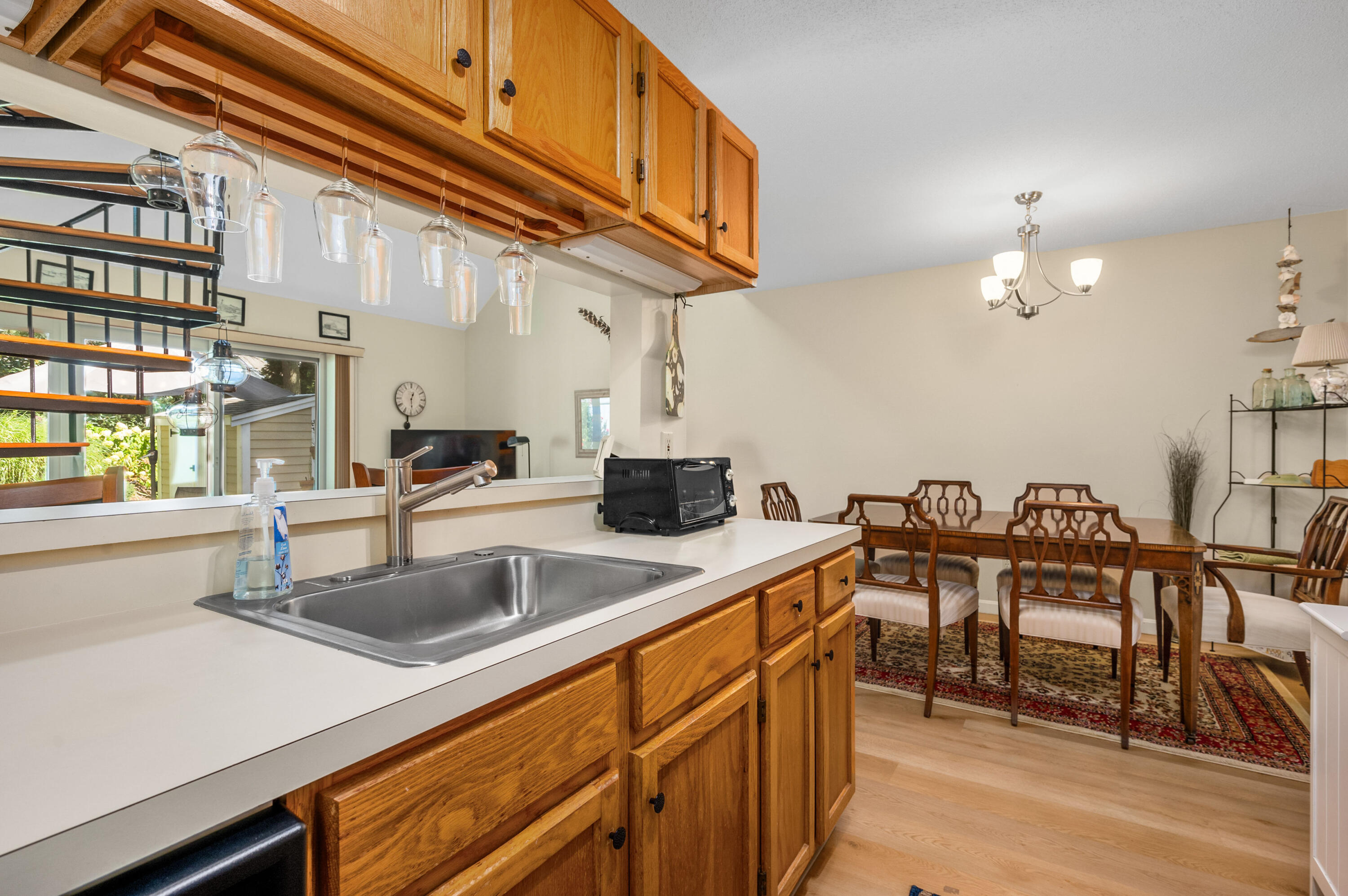 1 Howland Circle Brewster, MA 02631 - Photo 8 of 29 a kitchen with a sink cabinets and dining table