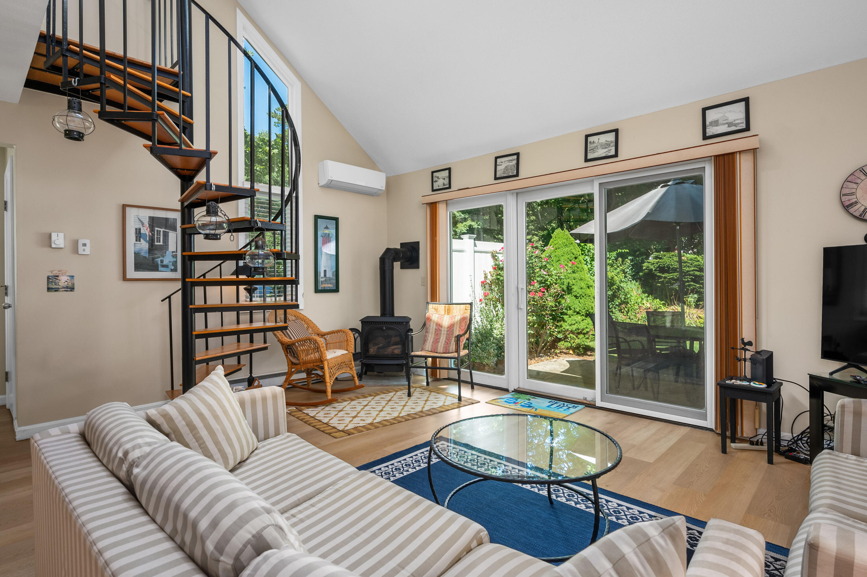 1 Howland Circle Brewster, MA 02631 - Photo 10 of 29 a living room with furniture a flat screen tv and a large window